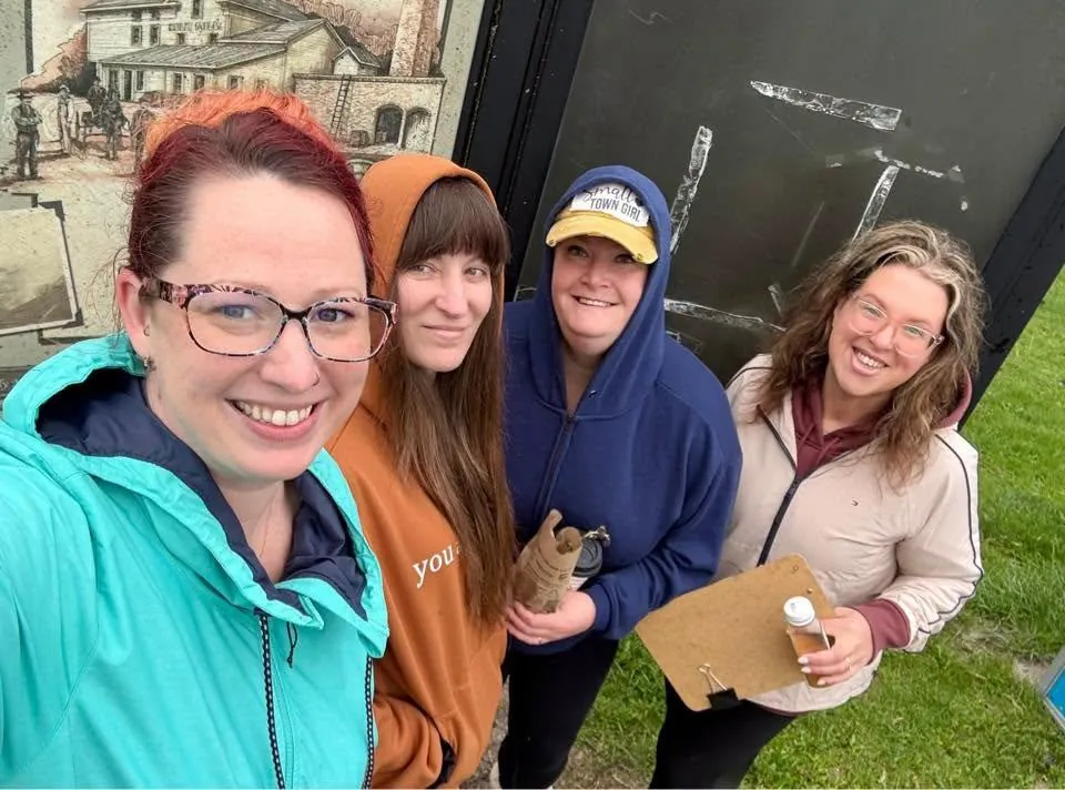 April, Shannon, Amber, and a volunteer together at a community park cleanup